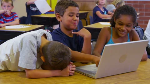 Three elementary school students look at laptop computer together Stock-Footage 62281972
