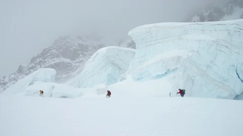 Three elite skiers walking on snow-covered mountain in slow motion Stock Footage 116789071
