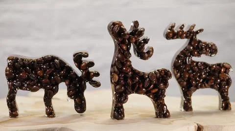 Three Elk Figures on Light Background Stock Photos