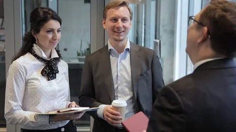 Three employees are talking standing in leading company. Video stock 83407059