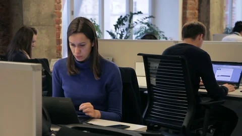 Three employees is working while sitting at laptops in modern office. Stock Footage 83148317