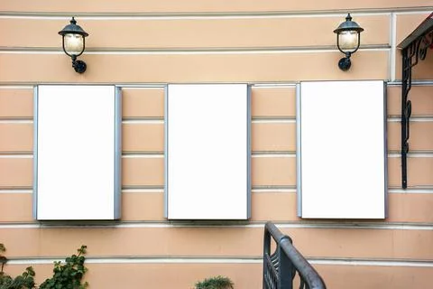 Three empty advertising banners mounted on building wall Fotos de archivo