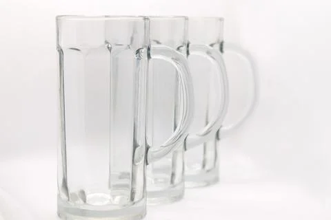 Three empty beer mugs with handles on a white background Stock Photos