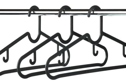 Three empty black coat / clothes hangers on a clothes rail Stock Photos