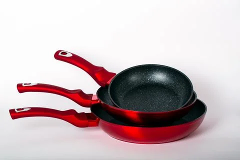 Three empty black-red frying pans on white background. Cooking At Home together  Foto stock