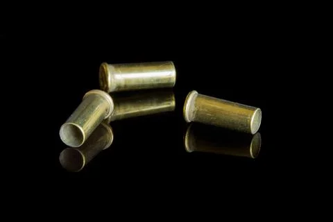 Three empty cartridges of small caliber bullets. Stock Photos