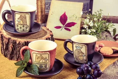 Three empty cups for tea on retro wooden table Stock Photos