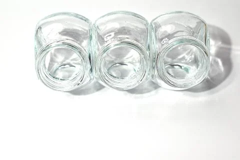 Three empty glass jars are unlikely. Isolate Stock Photos