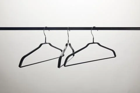 Three empty hangers stand isolated Stock Photos