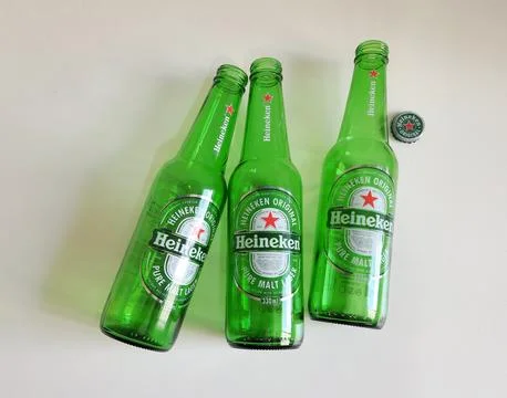 Three empty Heineken beer bottles in Sao Paulo, Brazil - Feb 2025 Stock Photos