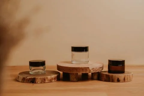 Three empty jars for your product on beige background Stock Photos
