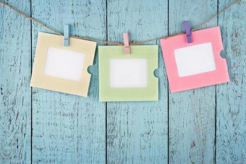 Three empty photo frames hanging with clothespins Stock Photos