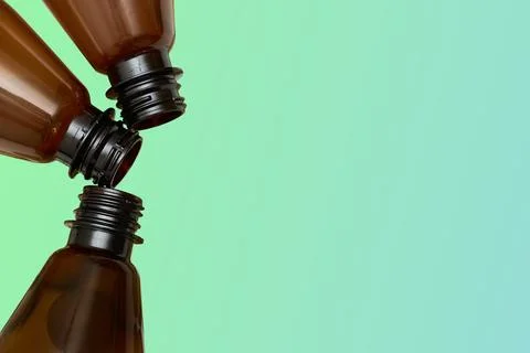 Three empty plastic bottles for alcohol and soda drinks on green gradient Stock Photos