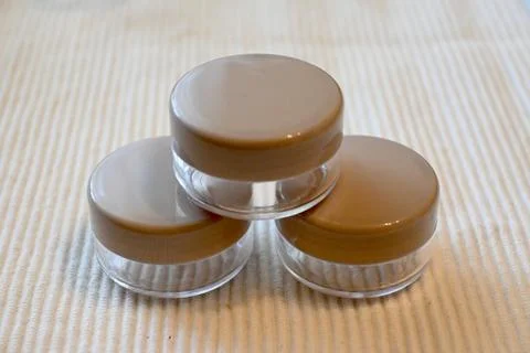 Three Empty Refillable Cosmetic Containers in Pyramid Arrangement, White Backgro Fotos Stock
