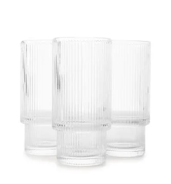 Three empty ribbed clear drinking glasses Stock Photos
