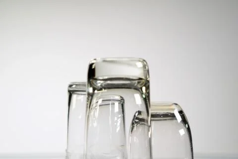 Three empty shot glasses on white background. Stock Photos