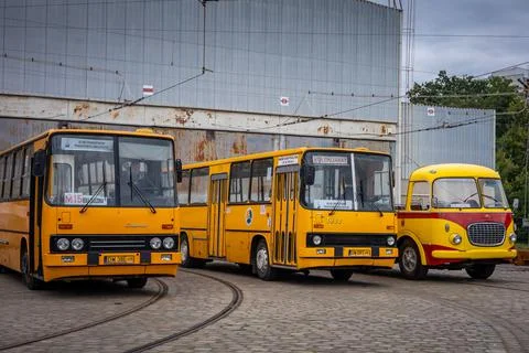 Three empty vintage buses in front of the depot. Stock Photos