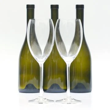 Three empty wine bottles and two glasses on a white background. Stock Photos