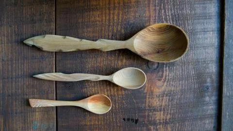 Three empty wooden spoons of different sizes Stock Photos