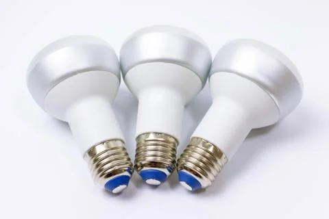Three energy saving lamp with e27 socket on white background Stock Photos