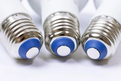 Three energy saving lamp e27 sockets on white background close up Stock Photos