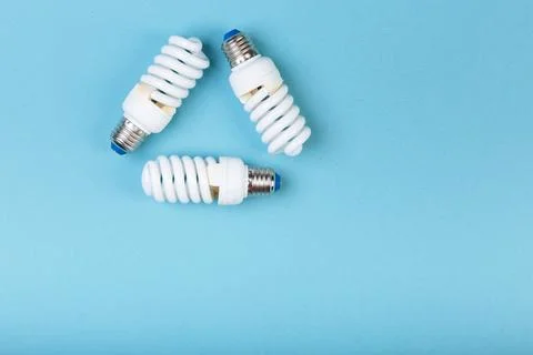 Three Energy saving lamps in the shape of a recycling symbol. Eco green energy Stock Photos