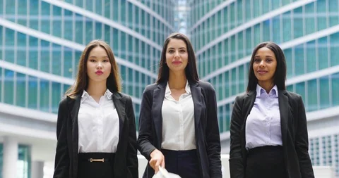 Three engineer women are putting on construction helmets and smiling in camera. Stock Footage 114917871