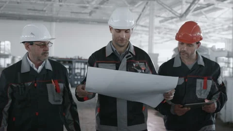 Three Engineers Planning Process of Machine Manufacture. Male Labor Person in Ha Stock Footage 199476115