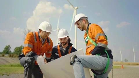 Three engineers was bending over and getting up to talk about the blueprint Stock Footage 236678915