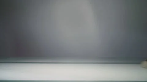 Three euro coins rolling on a table through the screen from left to right.   動画素材 47456887