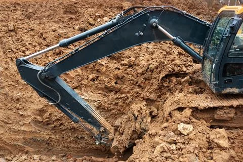 Three excavators in the process of work digs Foto stock