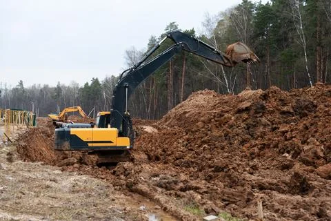 Three excavators in the process of work digs Stock-Fotos
