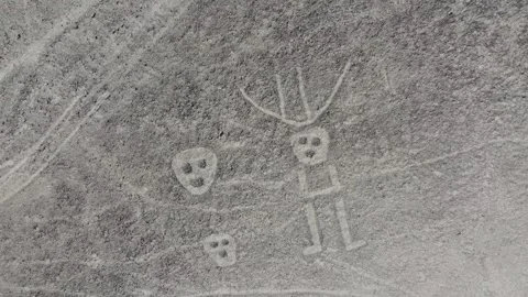Three face and multiple lines camera rising up of the Nazca Lines geoglyphs  Stock Footage 251938594