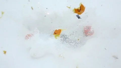 Three faces on orange fruits, two frowning and one with smile, middle explode 動画素材 84567583