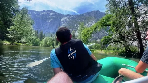 Three family members float down a river in Yosemite National Park in Stock Footage 197120143