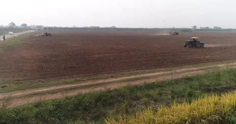 Three farm tractors working the wheat fields Stock Footage 291678723