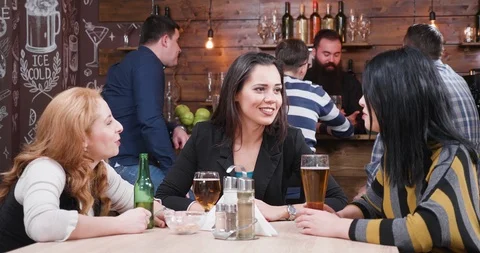 Three female friends at the pub drinking beer Stock Footage 102605200