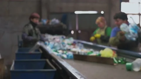Three female volunteers sorting plastic waste in a recycling factory. Stock-Footage 236200379