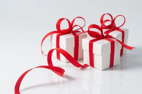 Three festive white gift boxes with red ribbon Stock Photos