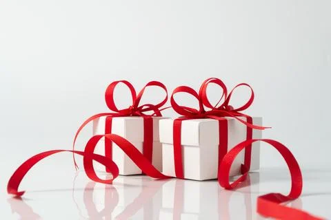 Three festive white gift boxes with red ribbon Stock Photos