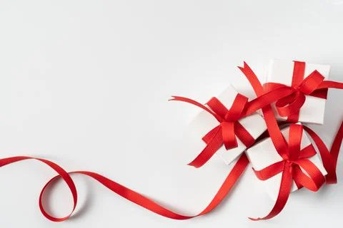 Three festive white gift boxes with red ribbon Stock Photos