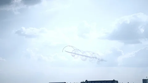 Three fighter jets in the blue sky. A general plan. Aerobatic figures. Airshow Stock Footage 124145994