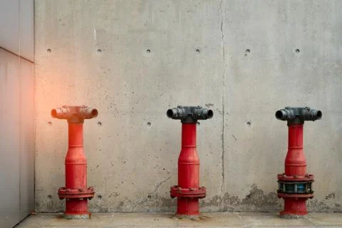 Three fire safety pump on cement floor of concrete building. Deluge system of 库存照片