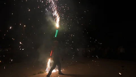 Three fire show performers standing in fire circle, performing. One juggles 動画素材 101048054