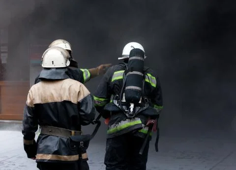 Three firefighters, going in a fire. Stock Photos