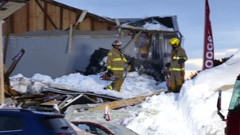 Three firefighters with shovel walking on collapsed roof Stock Footage 105287519