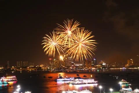 Three fireworks on beach and reflection color on water surface of light of ci Stock Photos