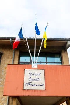 Three flags above civic building facade Stock Photos