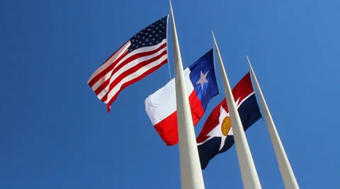 Three Flags in Downtown Dallas against blue sky Video stock 60796502