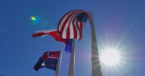 Three flags fluttering against sun, lens flare Video stock 61312723